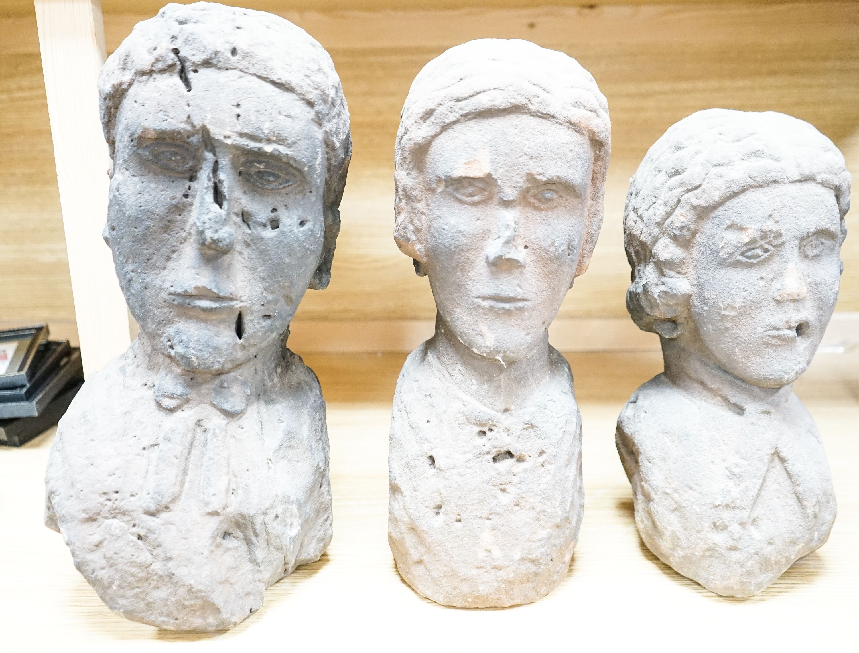 Three red sandstone busts of two ladies and a gentleman, 41cm